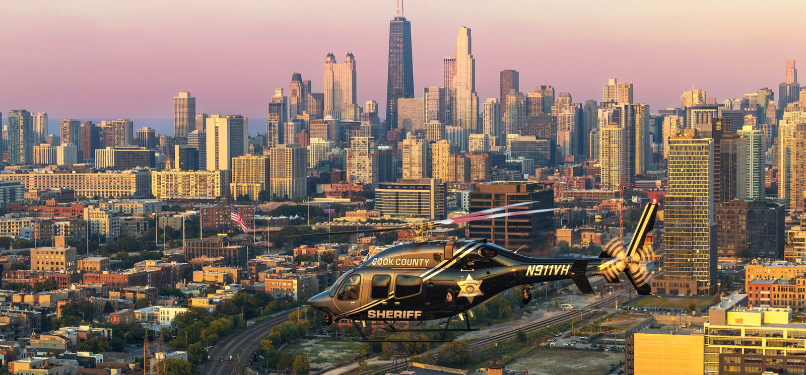A Helicopters Inc. law enforcement helicopter in flight, configured for airborne public safety missions